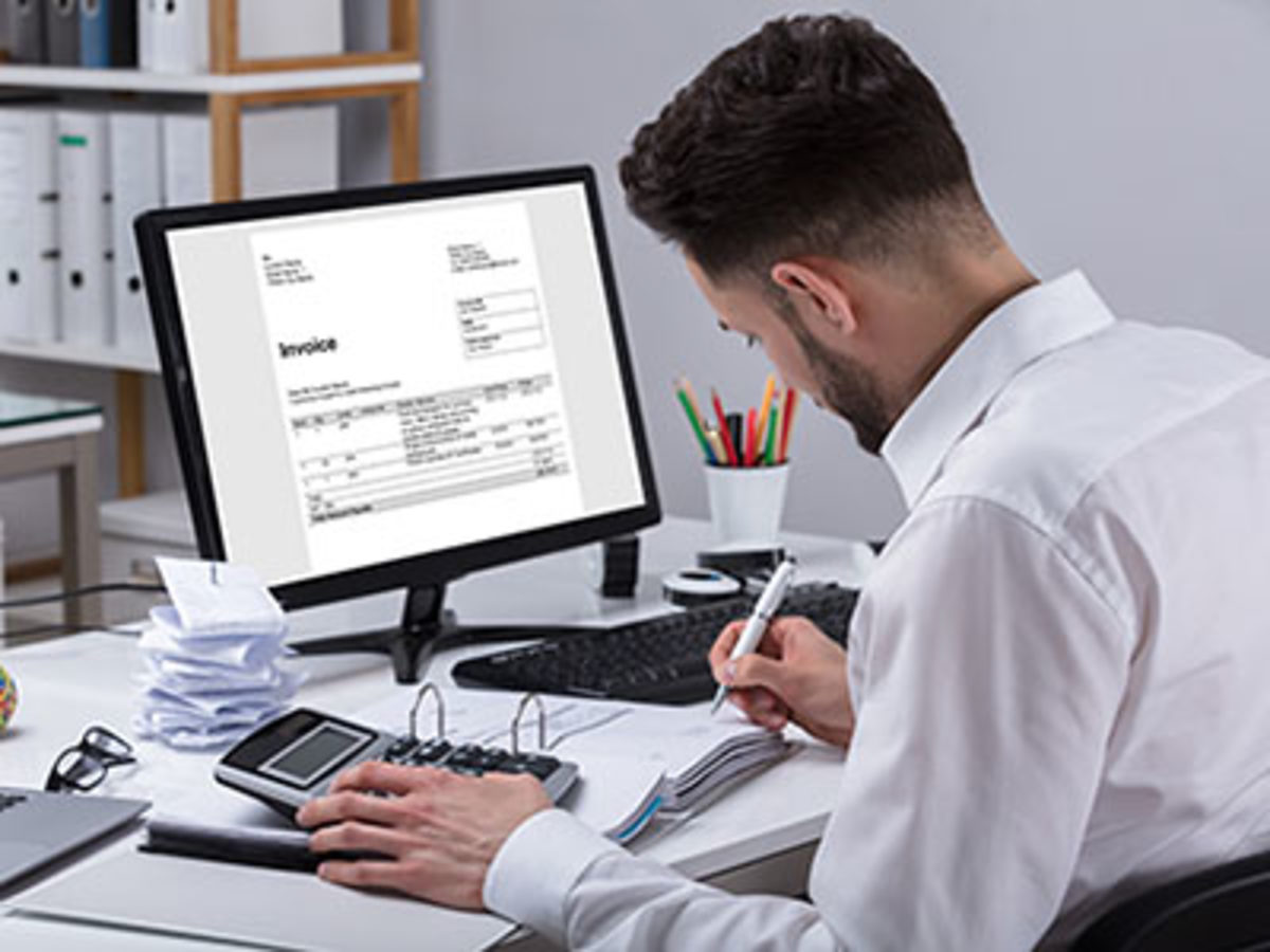 Young Businessman Calculating Invoice With Calculator At Desk Schlagwort(e): accountant, office, tax, taxes, calculator, invoice, business, man, accounting, desk, calculating, businessman, budget, screen, computer, account, side, advisor, worker, checkout