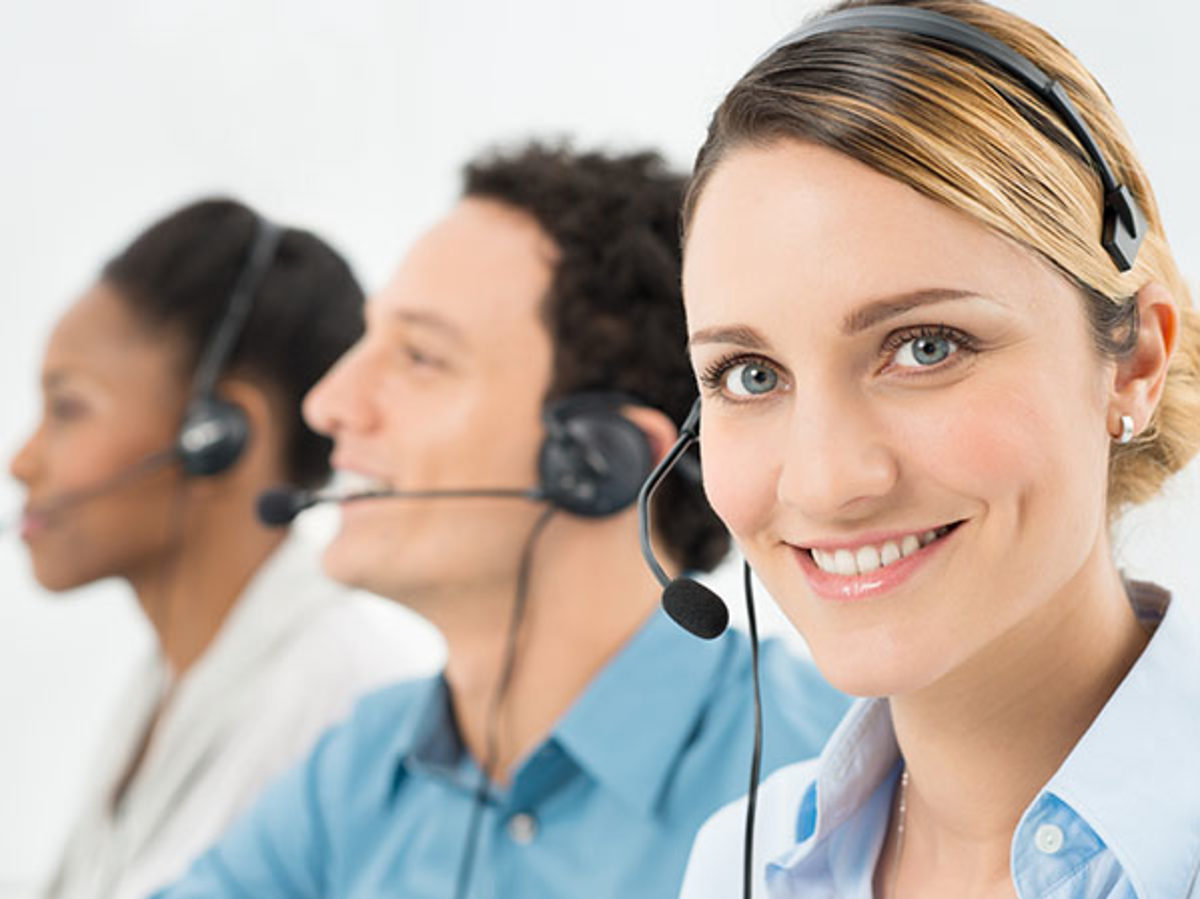 Smiling Woman With Headsets Working With Other Colleague In Call Center Schlagwort(e): customer, call center, happy, smiling, woman, it support, headset, portrait, colleague, businesswoman, office, caucasian, callcenter, african, black, afro, ethnicity, business, businesspeople, telephone, talking, headphone, people, multiracial, call, center, look, looking, work, job, man, communication, male, working, businessman, female, team, smile, young, help, joy, joyful, operator, contact, group, helpdesk, phone, speaking, row, consultant